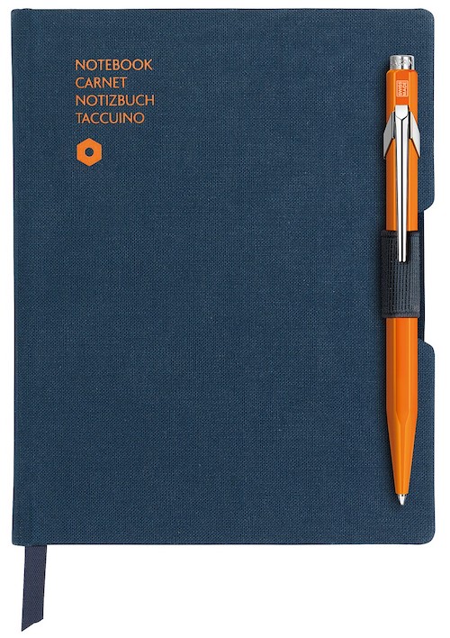 caran d'ache blue notebook orange pen