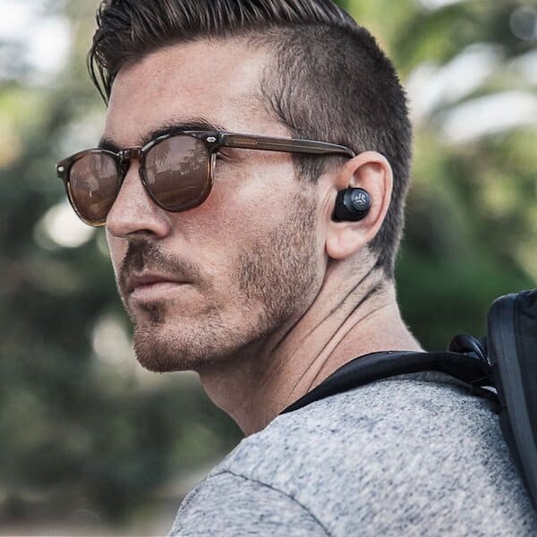 man wearing jbuds air true wireless earbuds