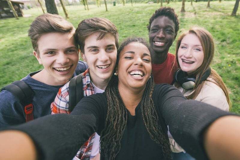 group of multi-ethnic teenagers taking a selfie