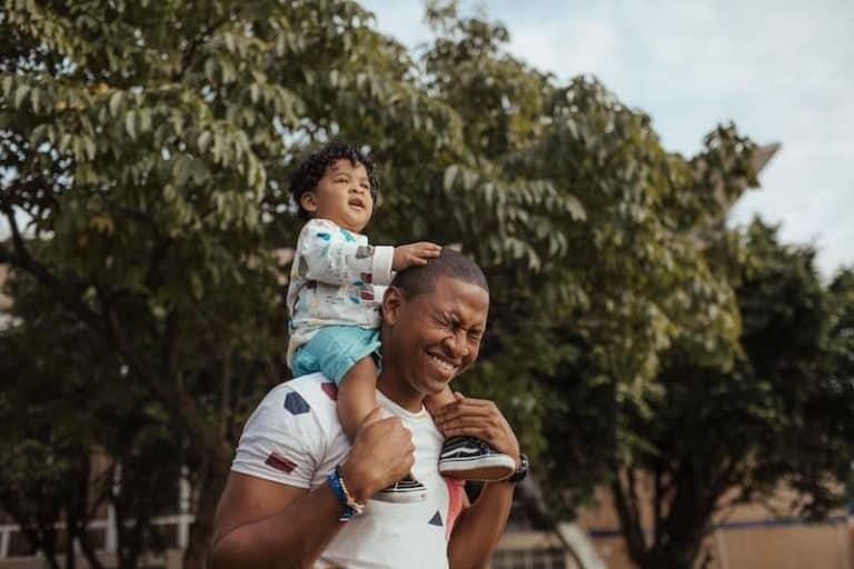 dad with son on shoulders
